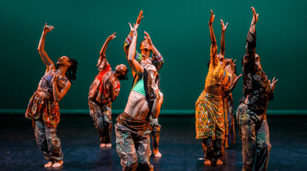 Lula Washington Dance showcase at APAP|NYC. Dancers are looking up with their right hands stretched upwards