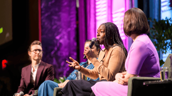 Bahia Ramos of the Wallace Foundation speaking at the Future of Performing Arts Funding session at APAPNYC 2025 (Photo by Adam KissickAPAP). She is wearing a tan sweater and has dark hair in braids.