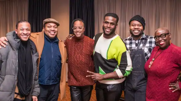 Six APAP Members smiling and posing for a photo in the Hilton hallway.